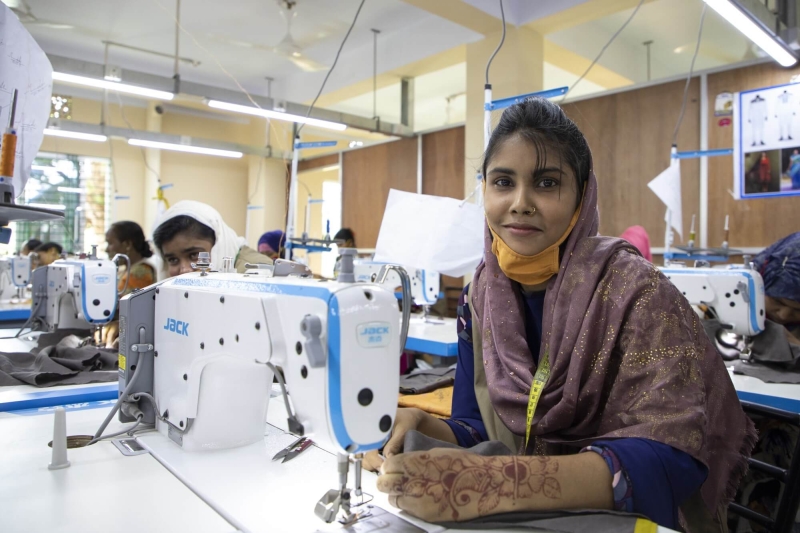 Bangladeshi sewing trainee, Taslima Jainat, produces garments at UNHCR supported workshop implemented by BRAC