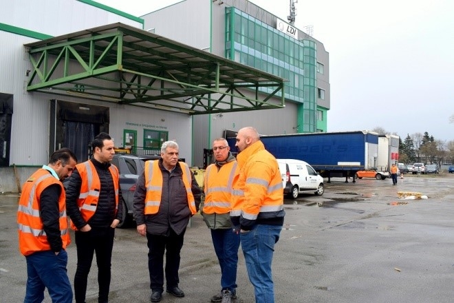 Men standing outside an industry site.