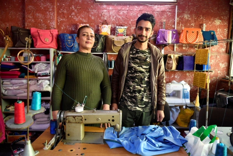 A woman and a man at a tailoring shop.