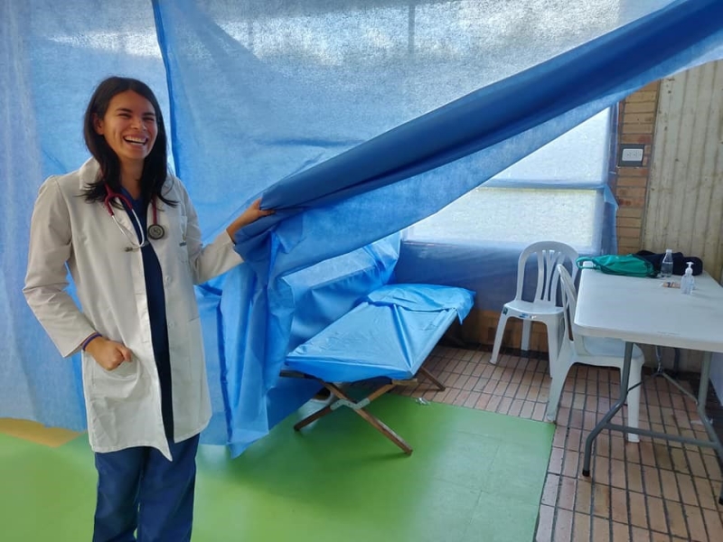 Woman standing next to a medical unit.