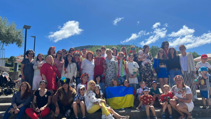 A group of people pose with a Ukrainian flag