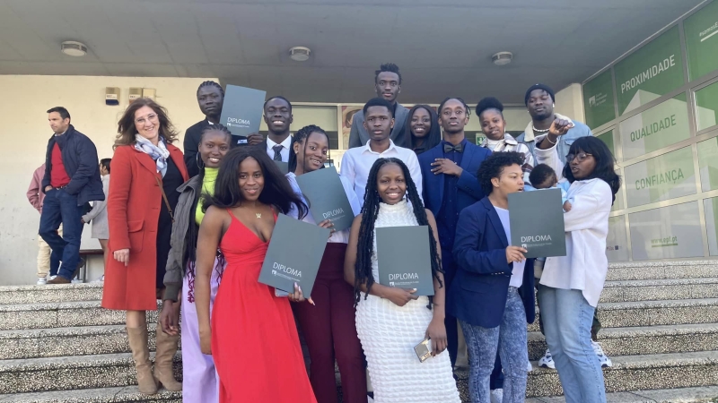 A group of students pose with their diplomas
