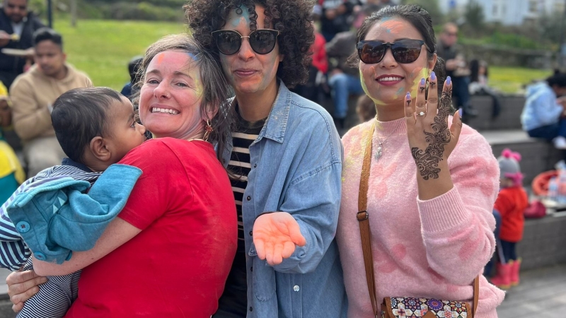 People pose for the camera with henna at a Holi Festival