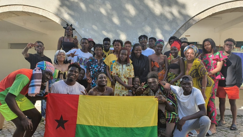 People pose with a Guinea Bissau flag