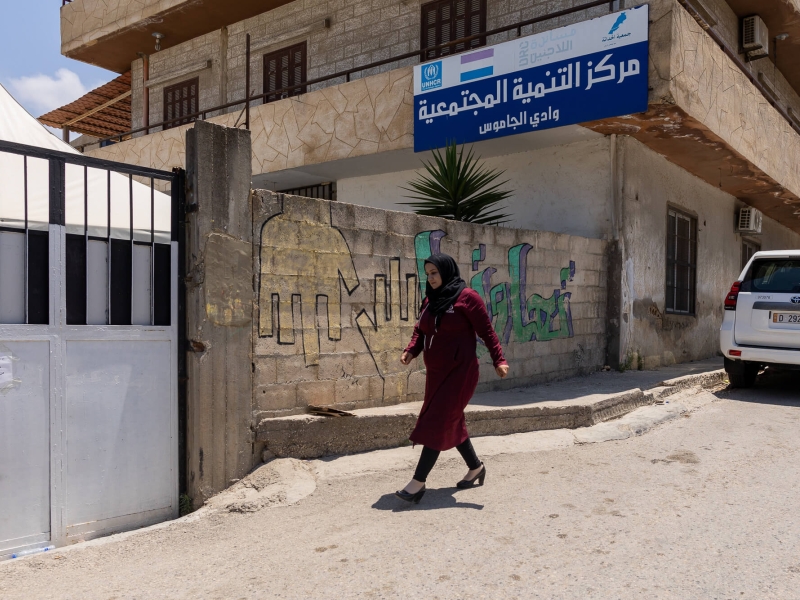 A woman walking in front of the Community Development Centre in Akkar, Lebanon