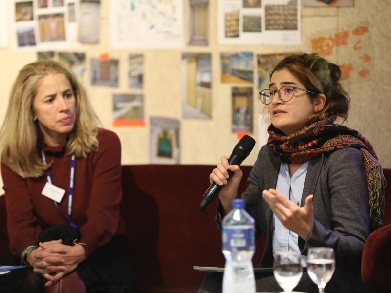 Two panellists talking into microphones at the event