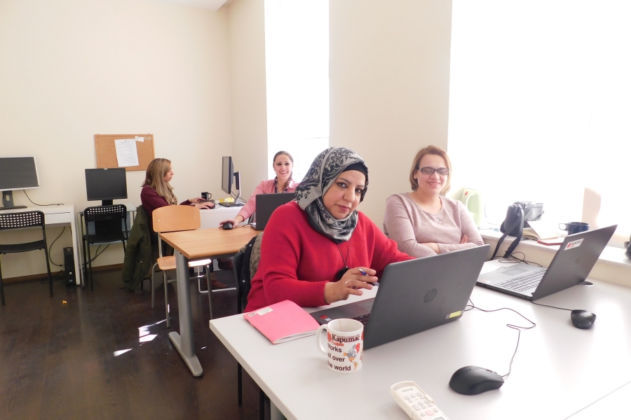 Women with laptops in a classroom.