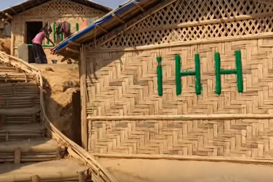 House made out of bamboo in a camp setting.