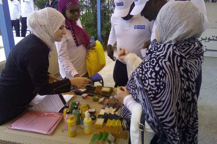Woman around a table selling soap.