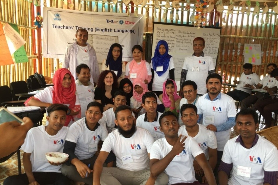 Group of people at a classroom setting in a camp.