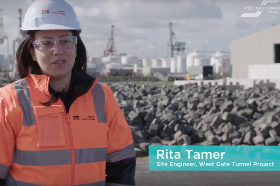 Still frame. A woman on a building site talks to camera