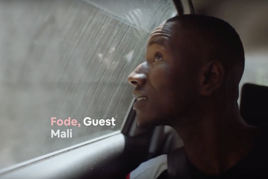 A young man looks out of a car window