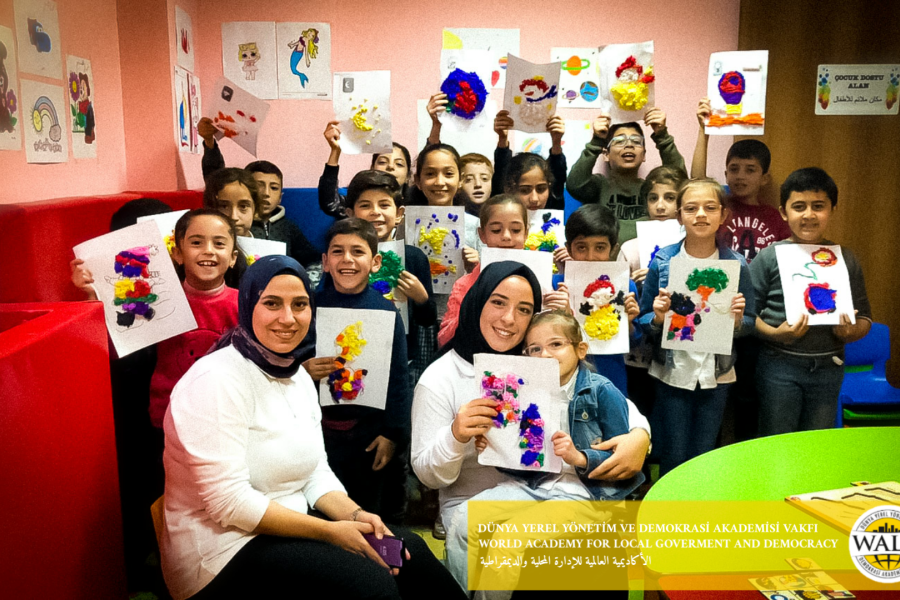 Woman and kids holding images facing the camera.