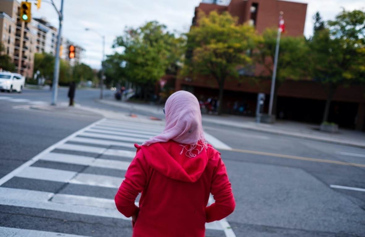 Woman waiting to cross a road