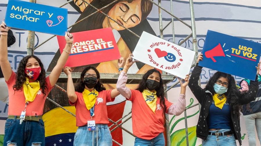 People wearing masks and holding up signs