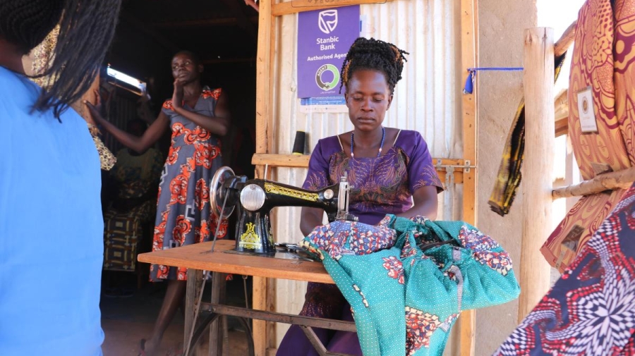 A woman is sewing a garment