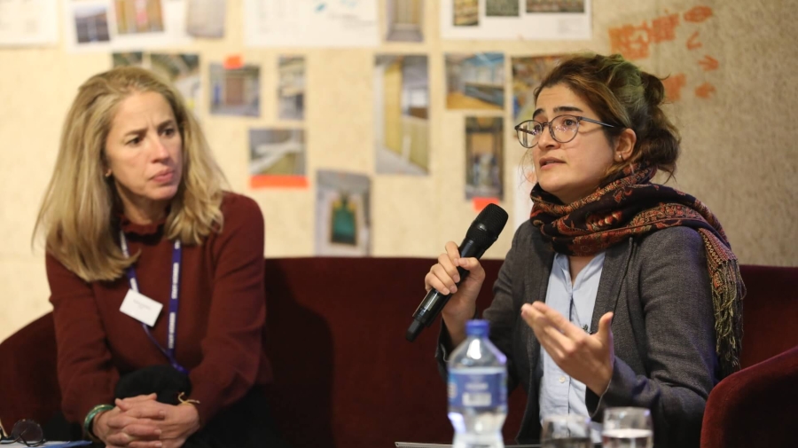 Two panellists talking into microphones at the event