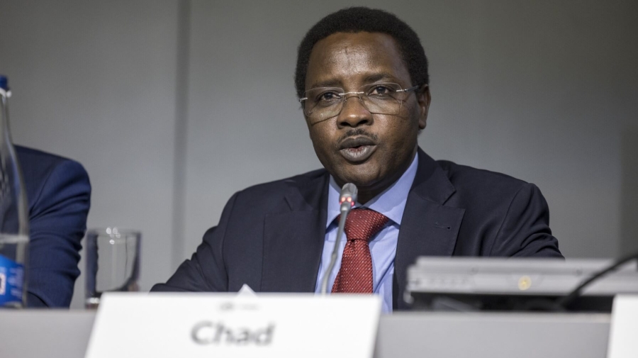 A man in a panel, speaking, with the nameplate of Chad in front of him