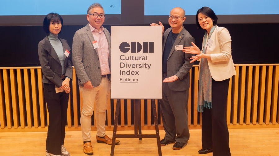 People standing in front of a sign that says "Cultural Diversity Index"